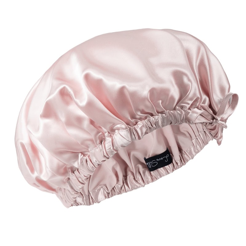 Weiche rosa Seidenkissenhülle mit Rüschendetails und Satinfinish.